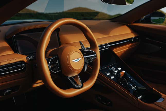 Front badge of a brown Aston Martin DB12 Volante