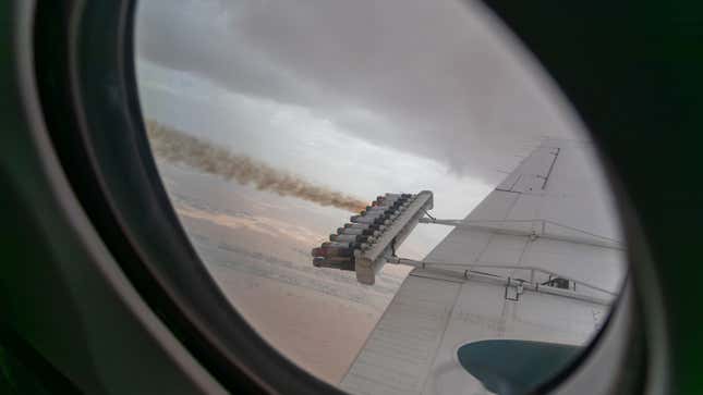 A photo of a plane spraying chemicals into the air to form clouds. 