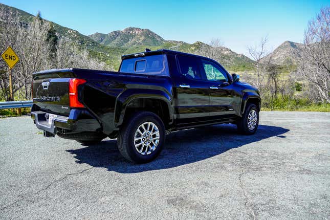 Rear 3/4 view of a black 2024 Toyota Tacoma Hybrid Limited