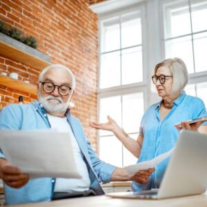 An angry couple looking at a document.