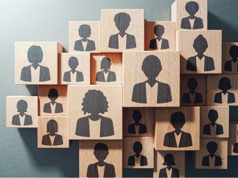 Top view of wooden cubes with icons of diverse people on them