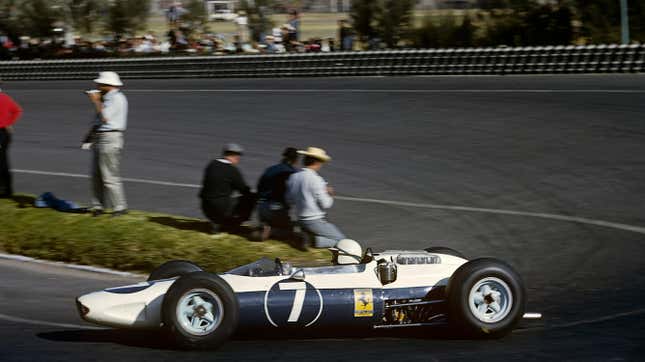 John Surtees, Ferrari 158, Grand Prix of Mexico, Autodromo Hermanos Rodriguez, 25 October 1964. Exceptionally, the Ferrari cars were not red in the 1964 Mexican Grand Prix, as they were entered by the NART (North American Racing Team), importer of Ferrari in America.