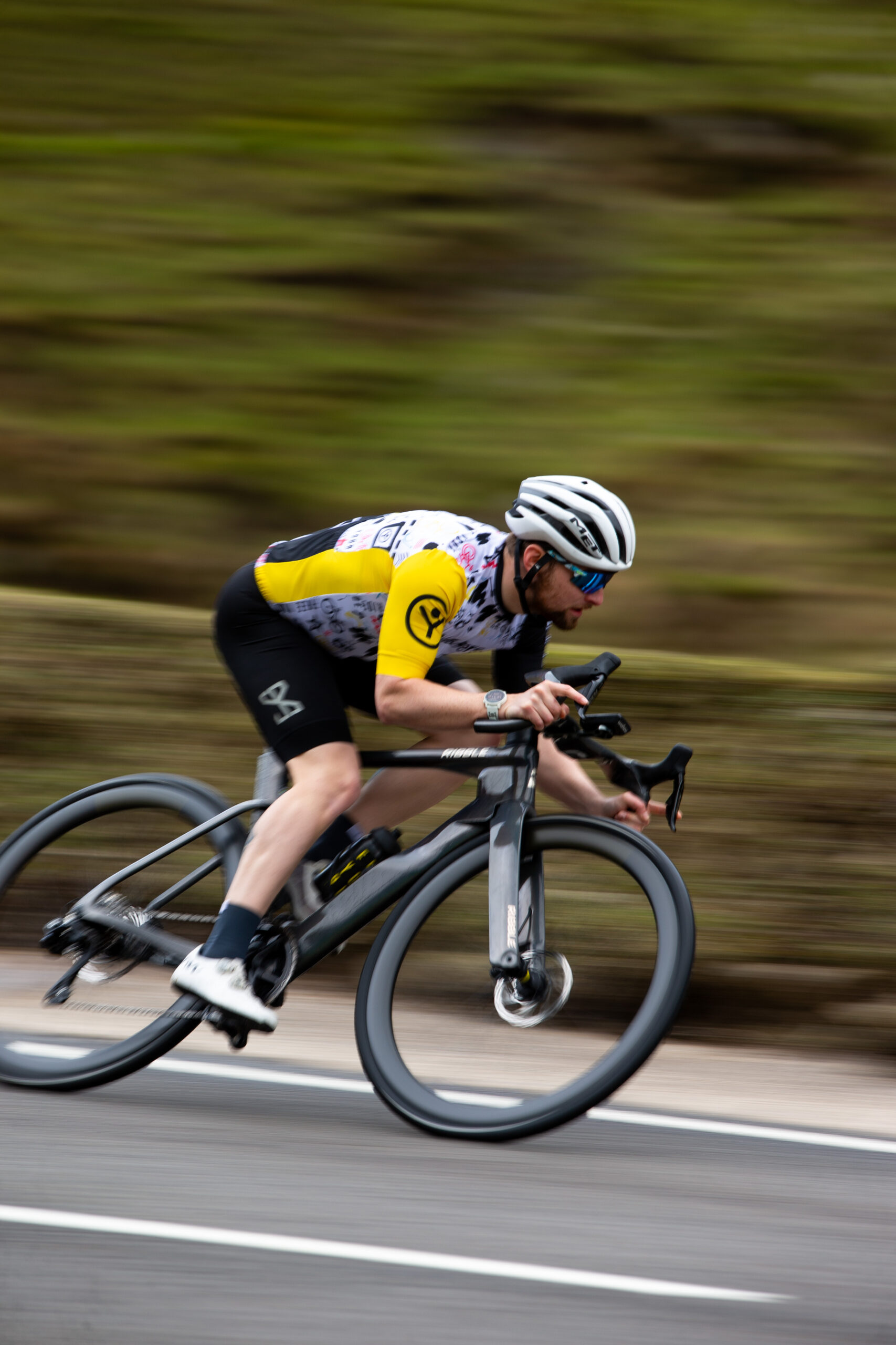 Triathlete descending quickly down a mountain road