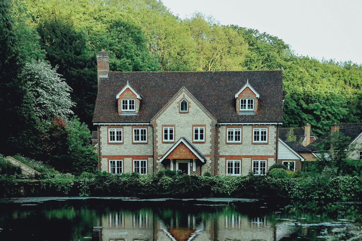 Brick house in London next to water and a forest