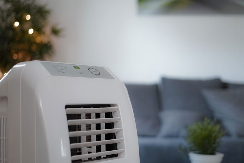 A photo of a portable air conditioner inside an apartment.