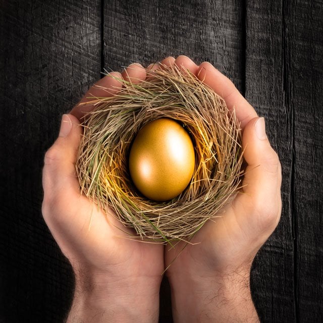 hands holding a golden nest egg symbolizing an inheritance