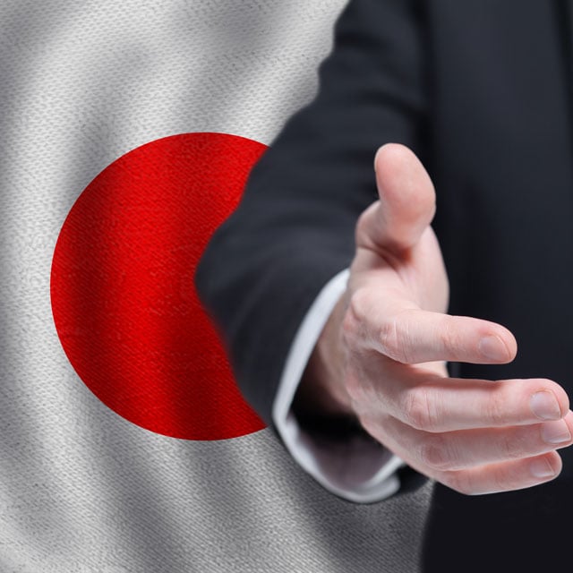 An outstretched hand with a Japanese flag