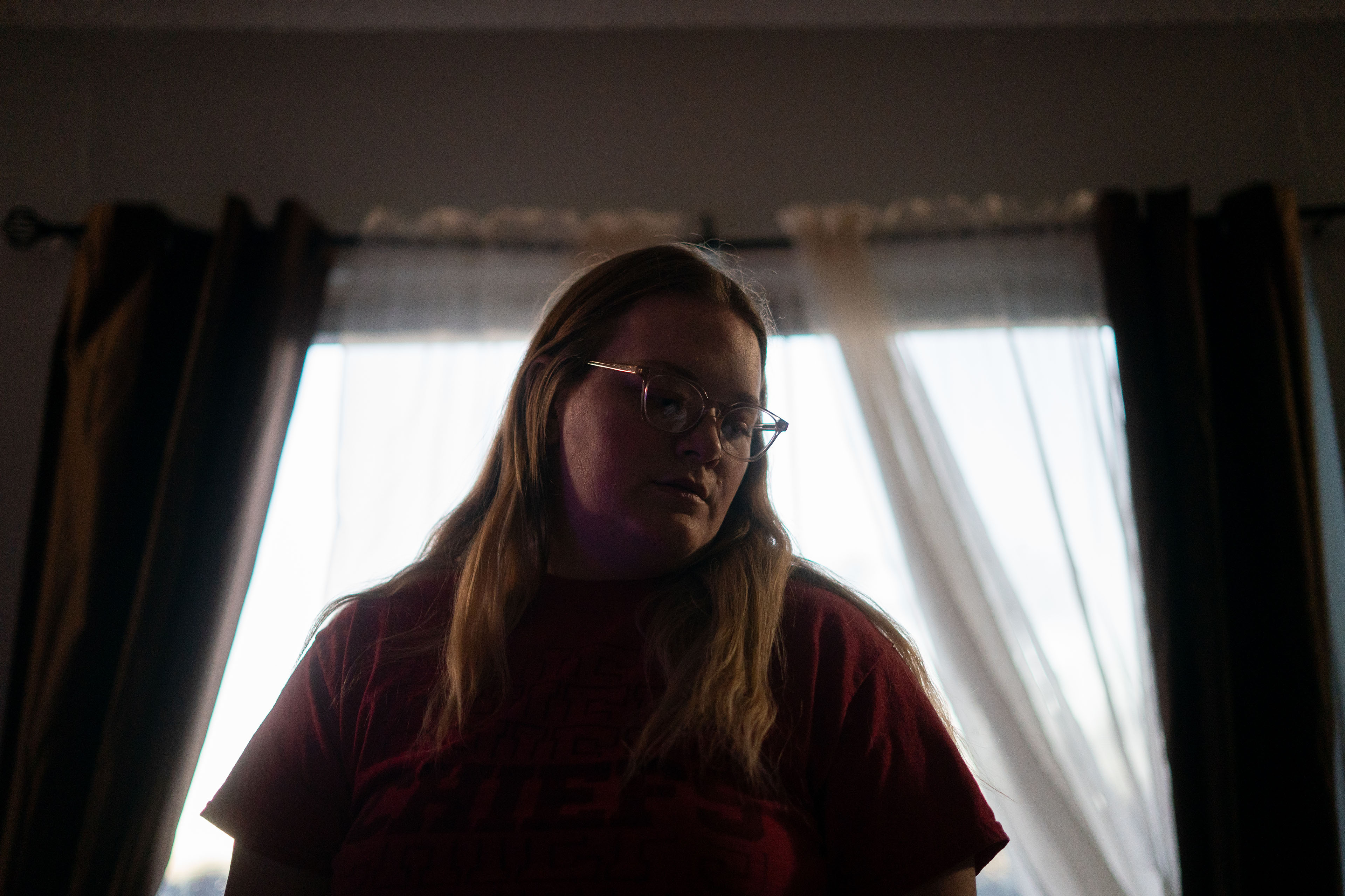 A back-lit portrait of Emily Tavis in her home.