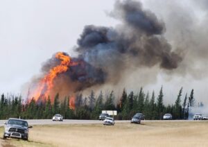 The 90,000 Fort McMurray residents who had fled their homes in 2016 had to wait until the hospital and other essential services were back up and running before they could return to their city. RCMP escort evacuees from Fort McMurray, Alberta past wildfires that are still burning out of control Saturday, May 7, 2016. THE CANADIAN PRESS/Ryan Remiorz
