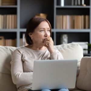 A serious-looking woman thinking.