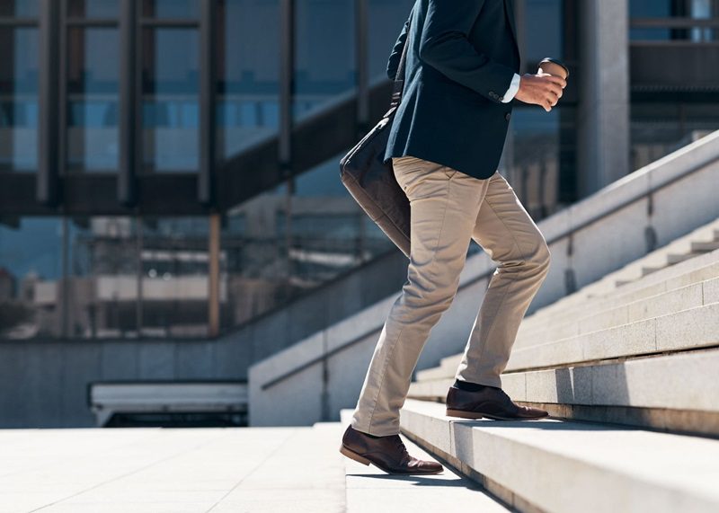 Businessman walking up a flight of stairs in an urban city