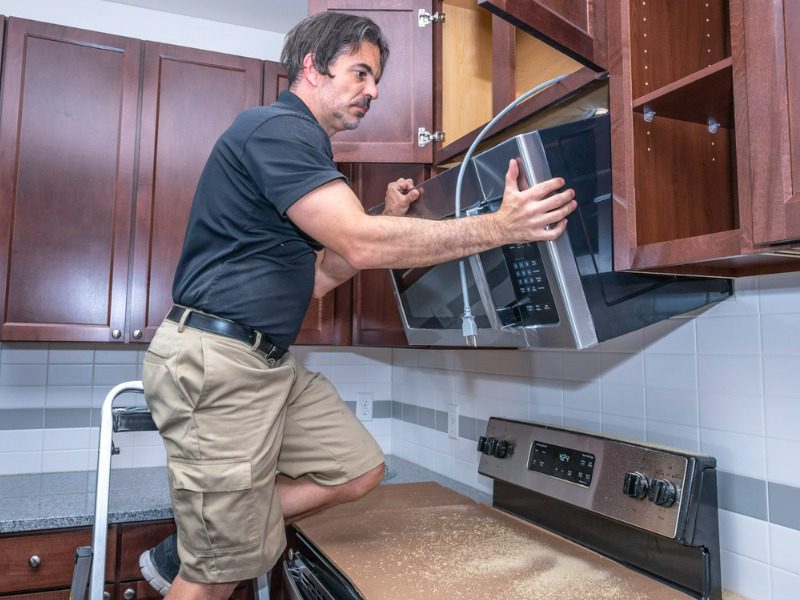 Appliance tech installs microwave