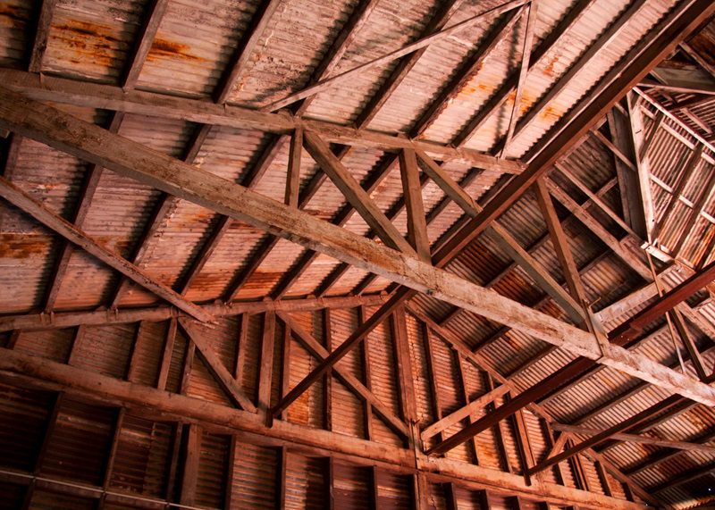 An old rusty wooden truss roof
