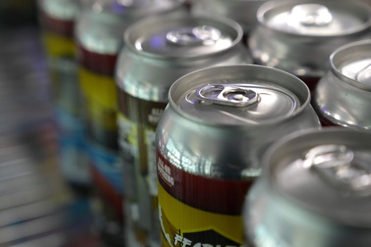 A close-up image of beer cans on a shelf