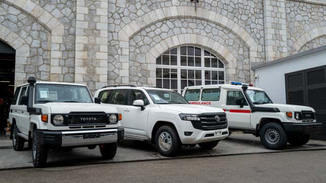 A photo of three modified Toyota trucks parked up. 