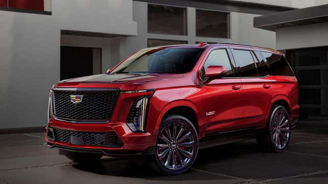 A red Escalade V parked in front of a house