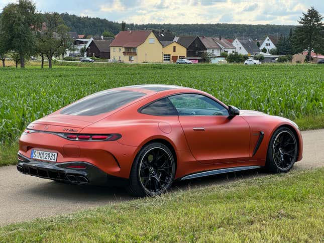 Rear 3/4 view of a matte orange 2025 Mercedes-AMG GT63 S E Performance