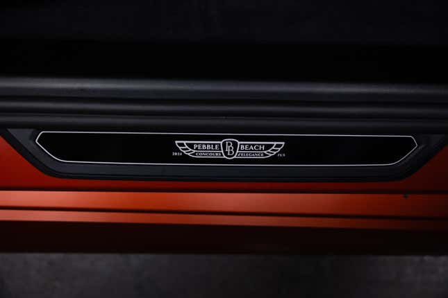 Door sill of a matte orange 2025 BMW M5