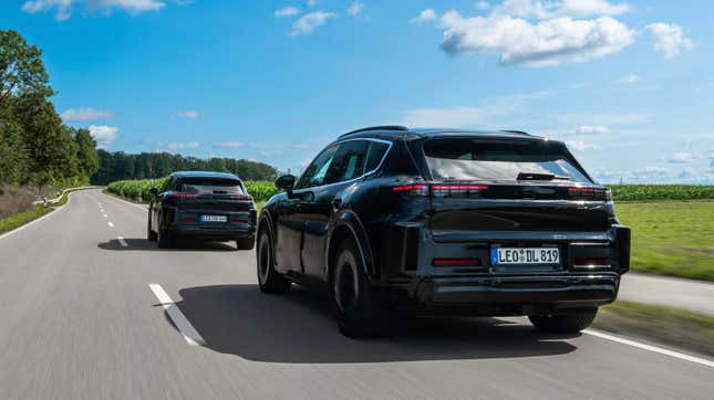 Rear 3/4 view of two camouflaged Porsche Cayenne EV prototypes