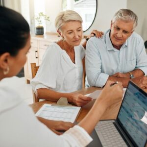 A senior couple talking to an advisor