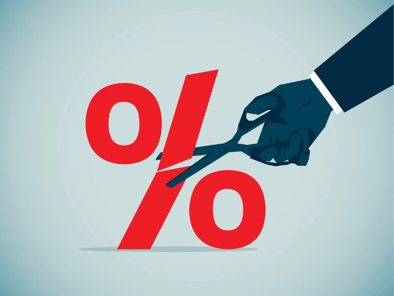 Cutting interest rate percentage sign with a pair of scissors