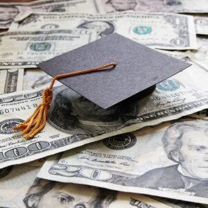 A college cap on a stack of money