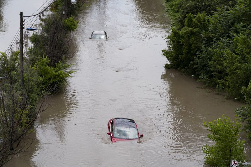 Cars are partially submerged in flood waters in the Don Valley following heavy rain in Toronto on July 16, 2024. THE CANADIAN PRESS/Arlyn McAdorey