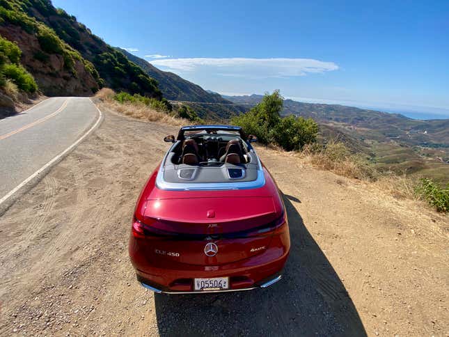 A photo of the rear of the CLE Cabrio with the top down parked on a cliffside in Malibu