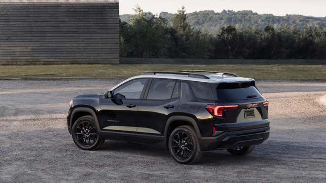 A rear 3/4 shot of a black terrain with a white roof 