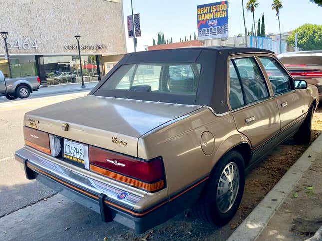 A rear 3/4 shot of the Cimarron parked on Sunset Blvd