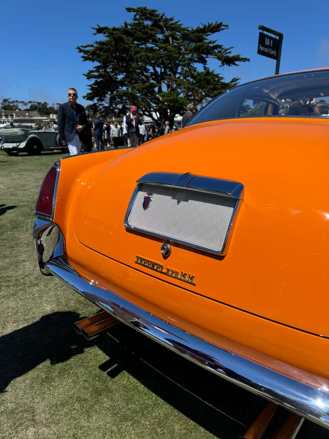 Rear end of an orange and grey 1954 Ferrari 375 MM Ghia Coupe