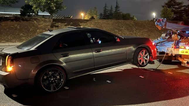 The 2007 Cadillac CTS being towed by police.