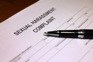 Someone filling out Sexual Harassment Complaint.