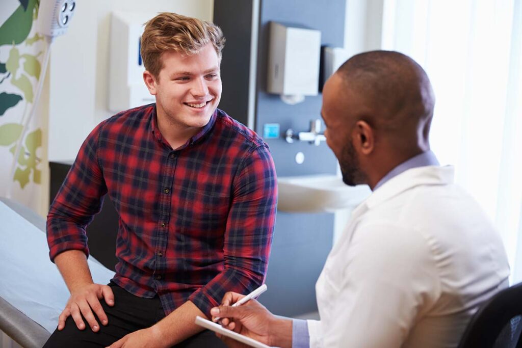 A young man talks with his new Primary Care Physician