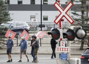 Railway workers walk a picket line after being locked out.