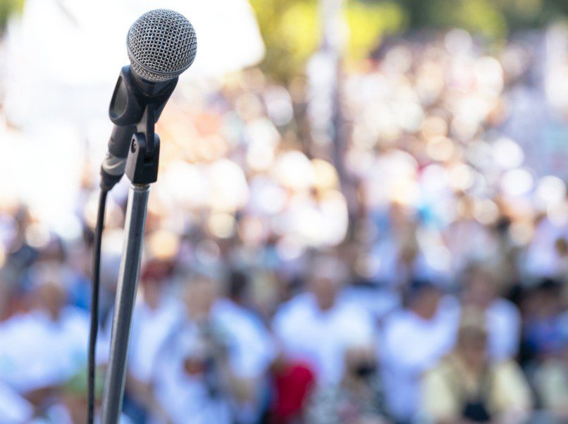 Political rally with microphone at the ready.