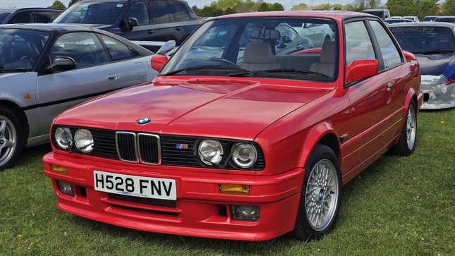 A red 1993 BMW 325i Sport