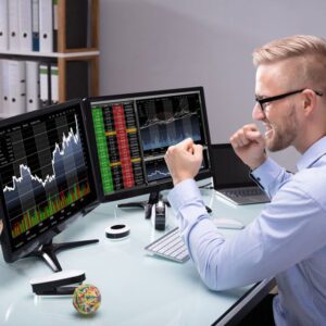 Excited stock trader looking at charts on a computer