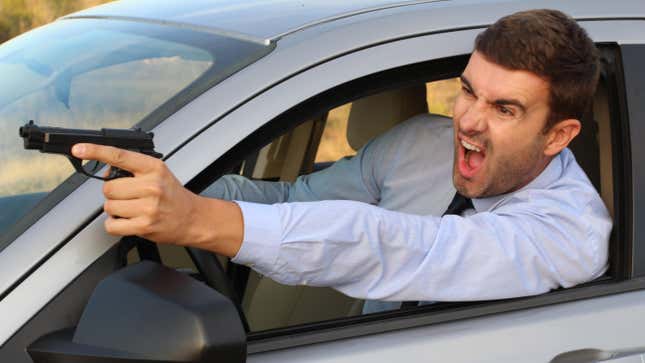 Stressed male driver yelling and holding a gun.