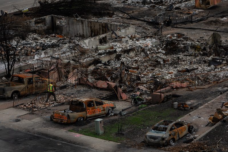 A worker walks in a devastated neighbourhood in west Jasper, Alberta on Monday August 19, 2024. The Insurance Bureau of Canada says the wildfire that tore through Jasper is the second-most expensive one in Alberta's history for insured losses. THE CANADIAN PRESS/Amber Bracken