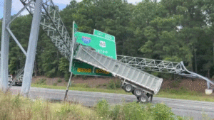 Trailer-Tractor Plows Into Highway Exit Sign, Ripping Raised Bed Off Cab