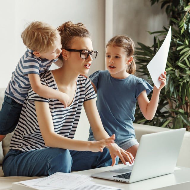 Stressed woman with kids working from home