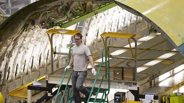 A Boeing employee walk out from a Boeing 777 passenger plane fuselage section on one of the assembly lines February 14, 2011 at the company's factory in Everett, Washington. 