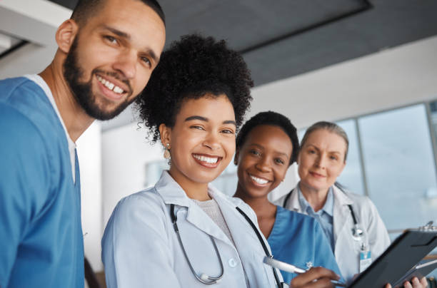 Medicine, doctors and healthcare team at work with smile for medical portrait, diversity and teamwork in Canada hospital. Trust, collaboration or cardiology with nurse, worker or clinic employees Medicine, doctors and healthcare team at work with smile for medical portrait, diversity and teamwork in Canada hospital. Trust, collaboration and motivation with nurse, worker or clinic employees health insurance specialist stock pictures, royalty-free photos & images