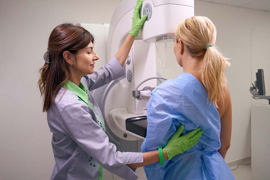 A radiographic technician performs a mammogram