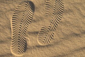 Shoe marks in the sand. Beautiful sand background with geometric pattern.