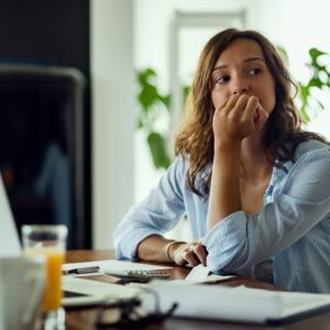 Worried woman while working on home finances