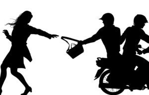 Editable vector silhouette of two men on a motorcycle stealing a handbag from a woman with figures, handbag and bike as separate objects