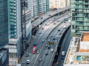 High angle view of busy daytime traffic coming into central Toronto in Canada, passing downtown towers.