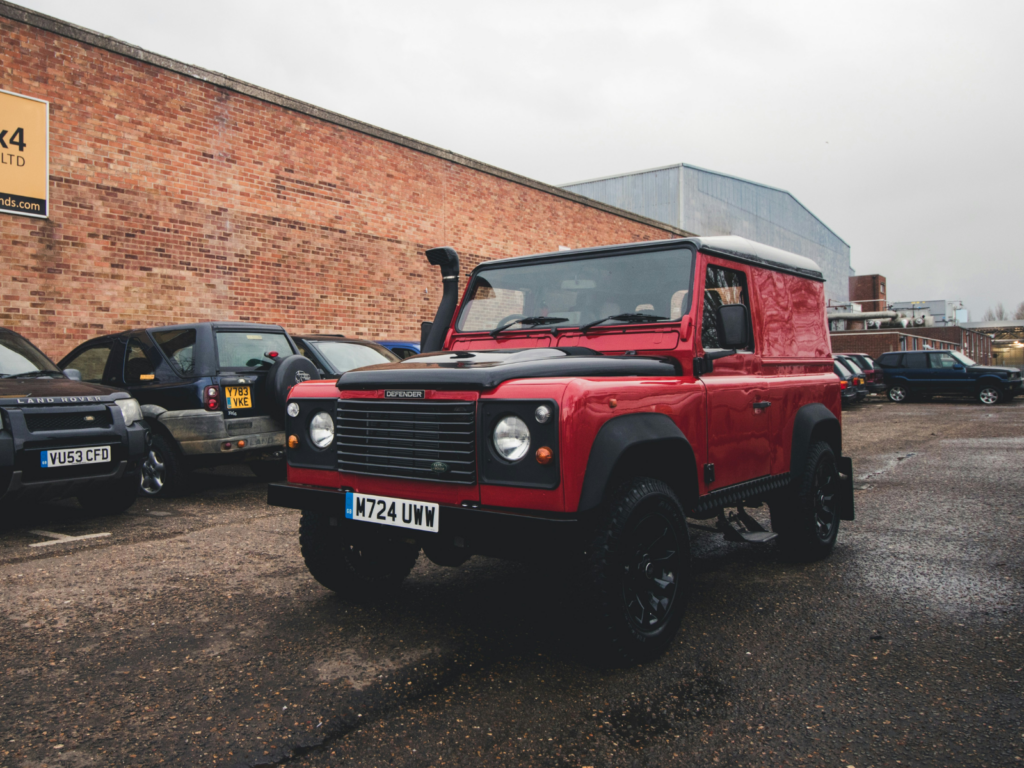 Red Land Rover parked in British car park 